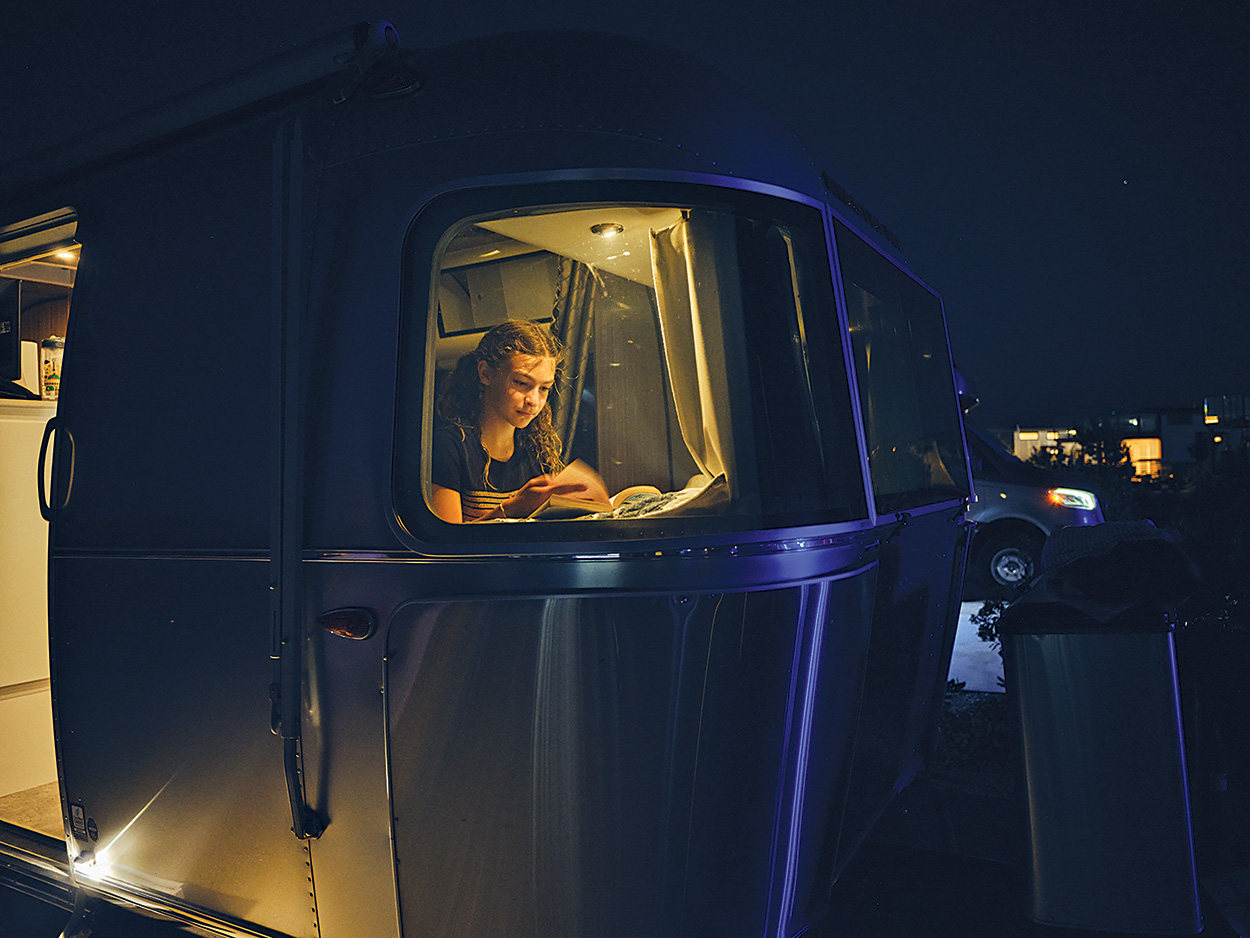 The Escape Pod A Cayenne eHybrid towing an airstream trailer pulls a