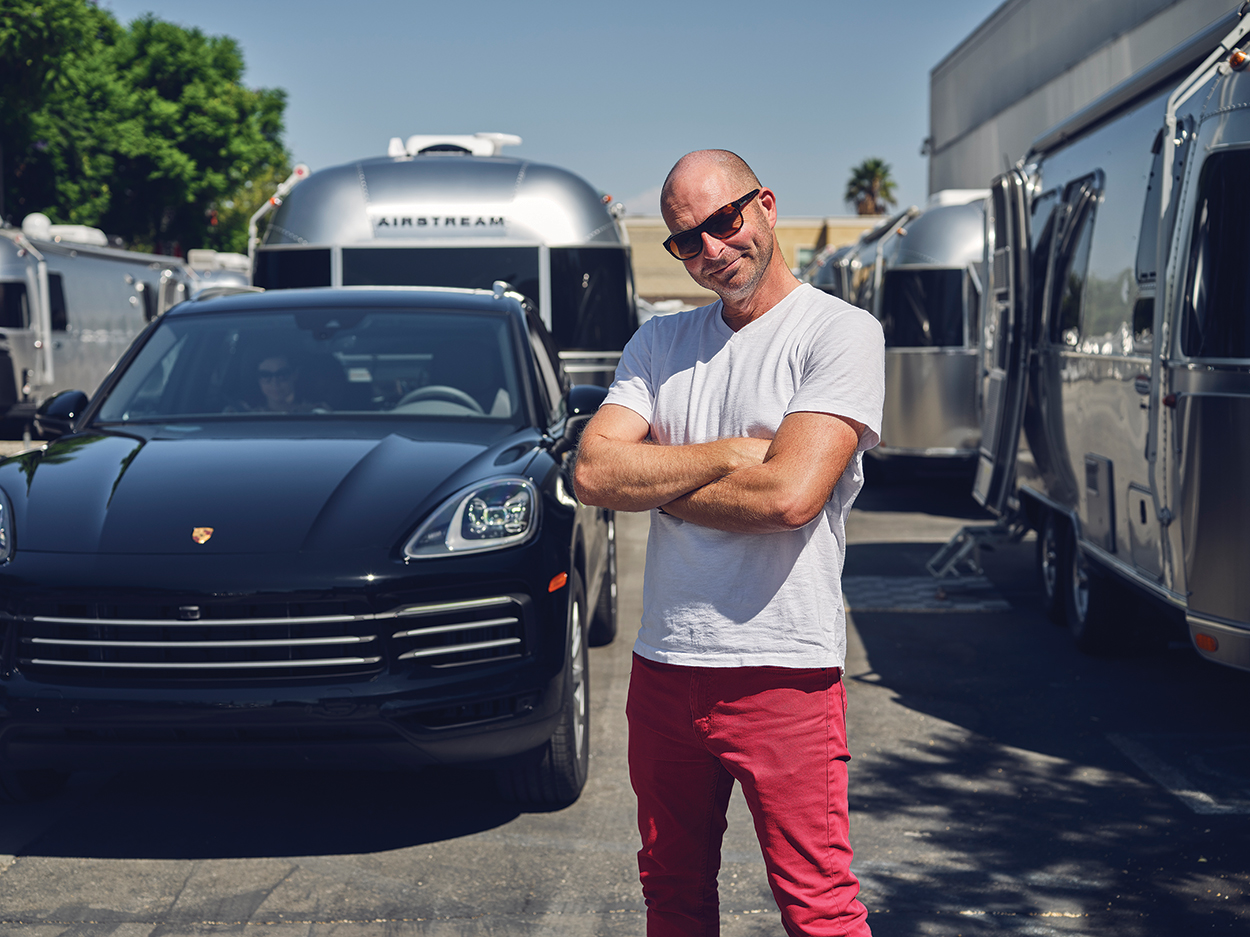 The Escape Pod A Cayenne eHybrid towing an airstream trailer pulls a