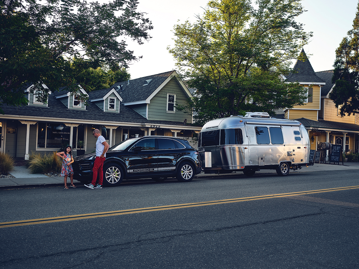 The Escape Pod A Cayenne eHybrid towing an airstream trailer pulls a
