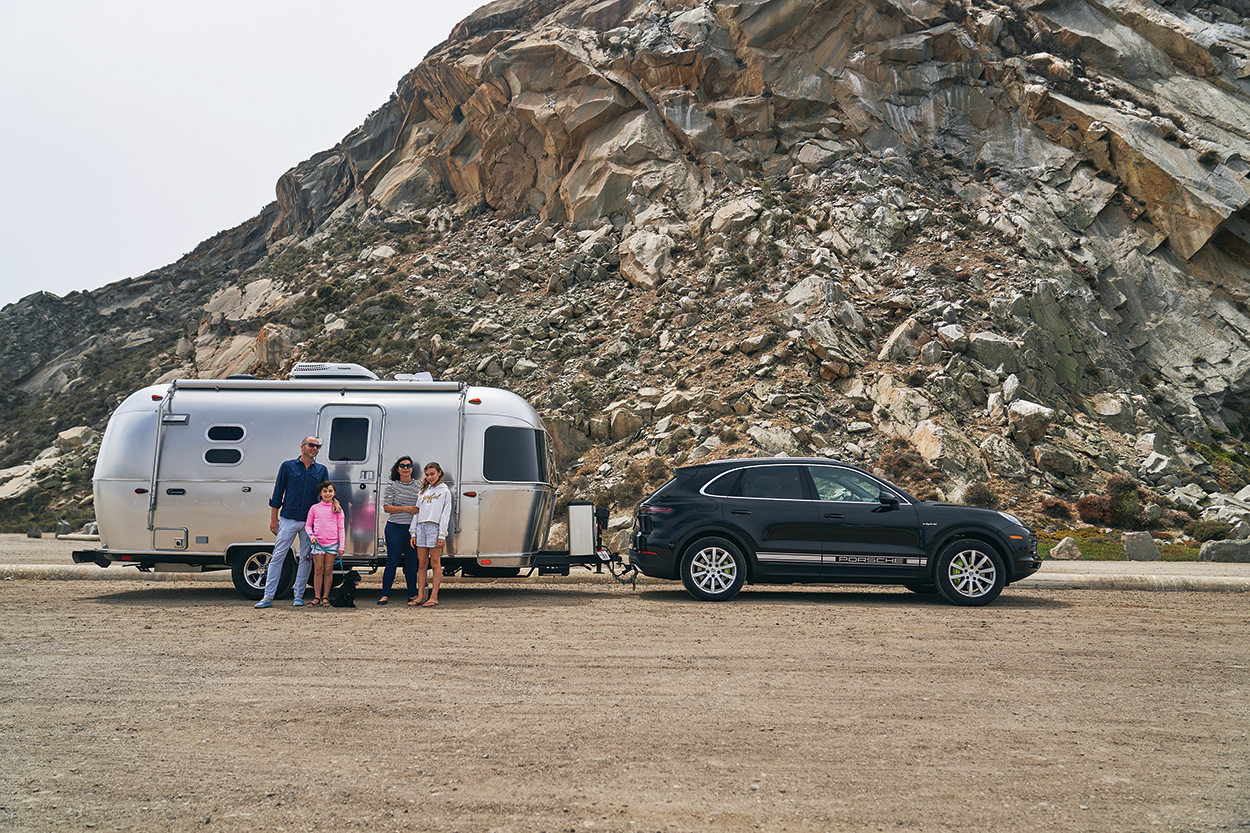 The Escape Pod A Cayenne eHybrid towing an airstream trailer pulls a
