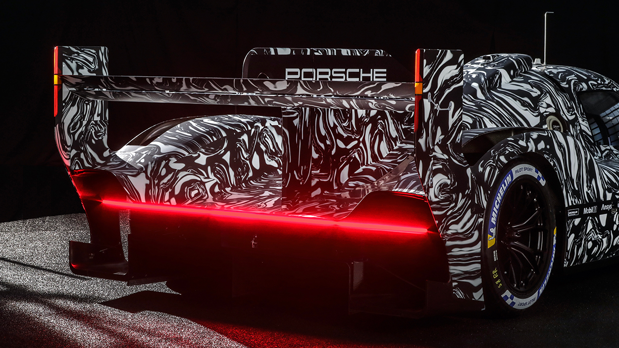photo of Porsche shows us the rear of its new, still-heavily-camouflaged LMDh race car image